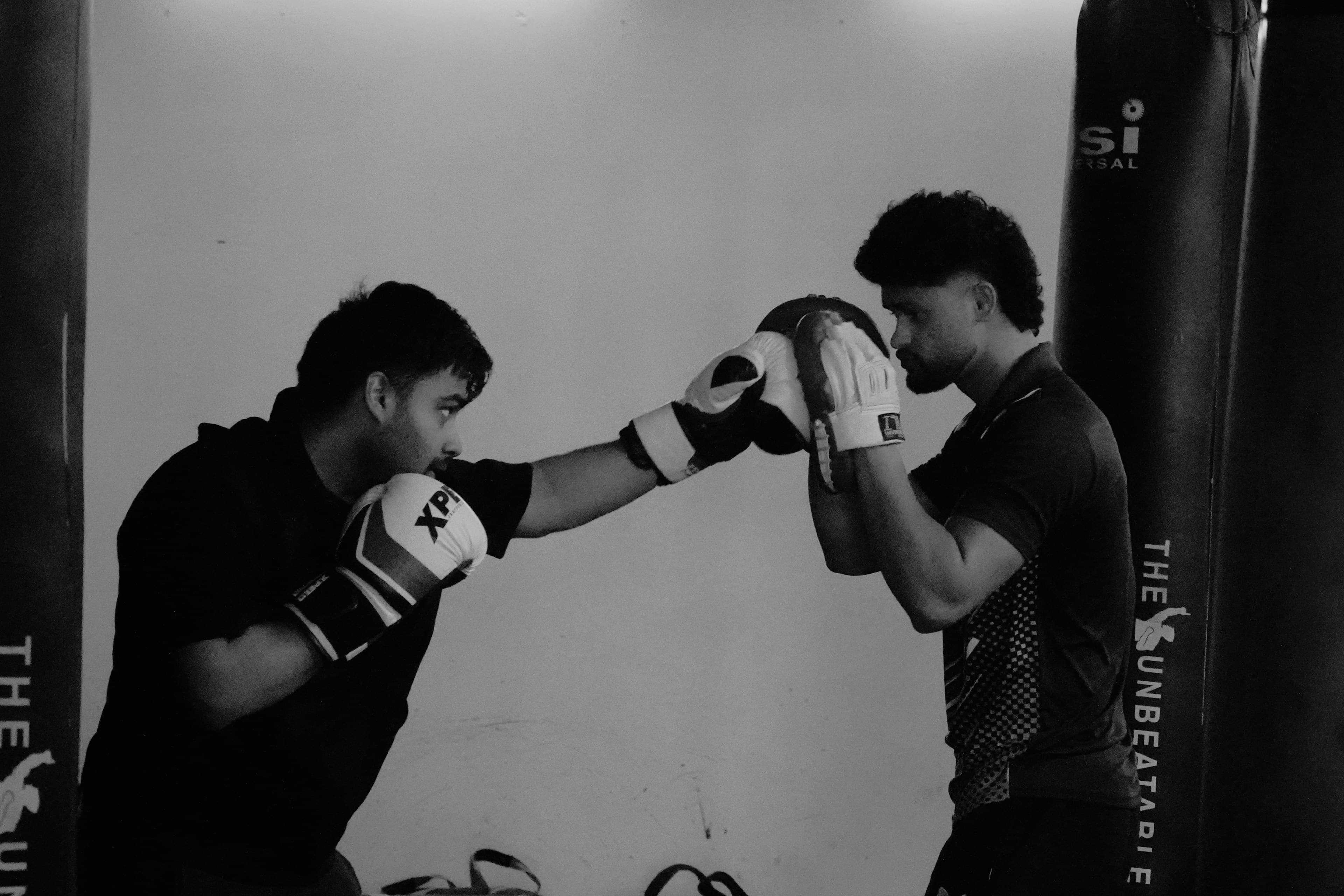 A boxing coach working with an athlete